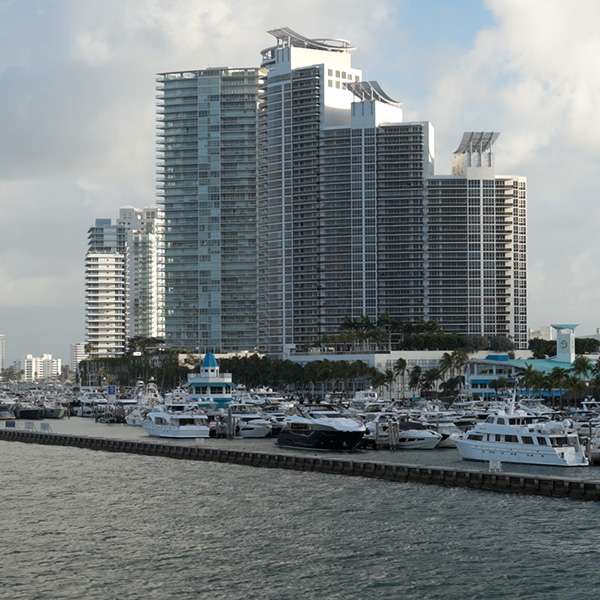 Condominium towers of Miami Beach behind moored yachts, Florida, USA