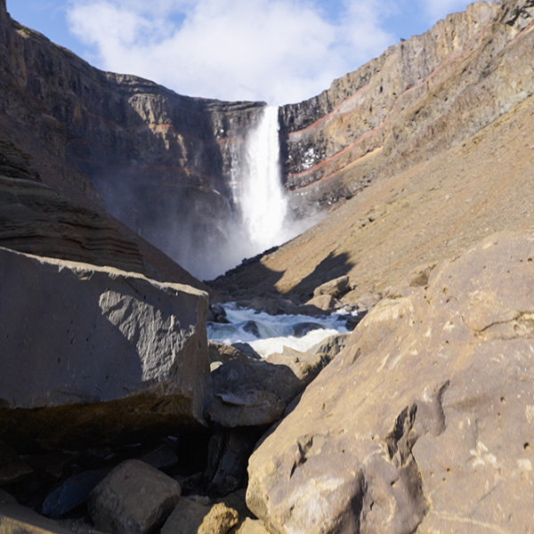 Hengifoss waterfall cascading 118 meters down red and black volcanic rock layers