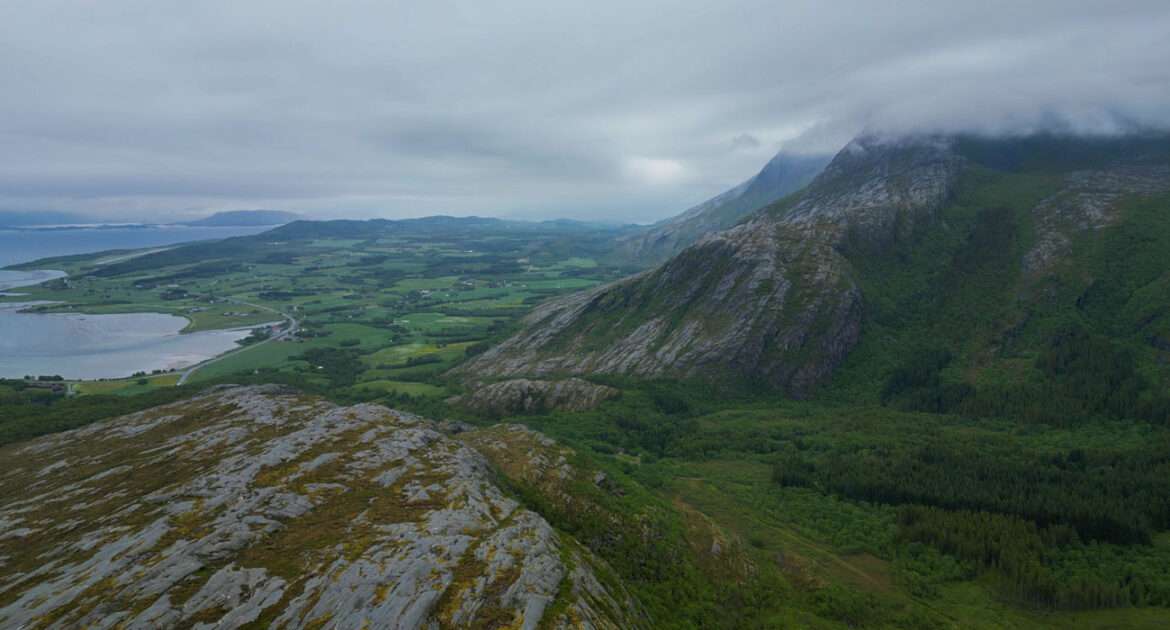 View from the Vettfjellet hill over the Helgeland coast near Sandnessjøen, sea and islands under cloud, Norway