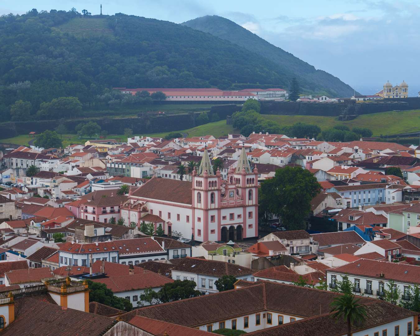 The pink twin towers of Angra cathedral among the roofs of the old town