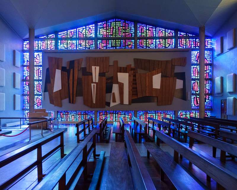 Chapel at Buckfast Abbey lit deep blue by stained glass on every wall