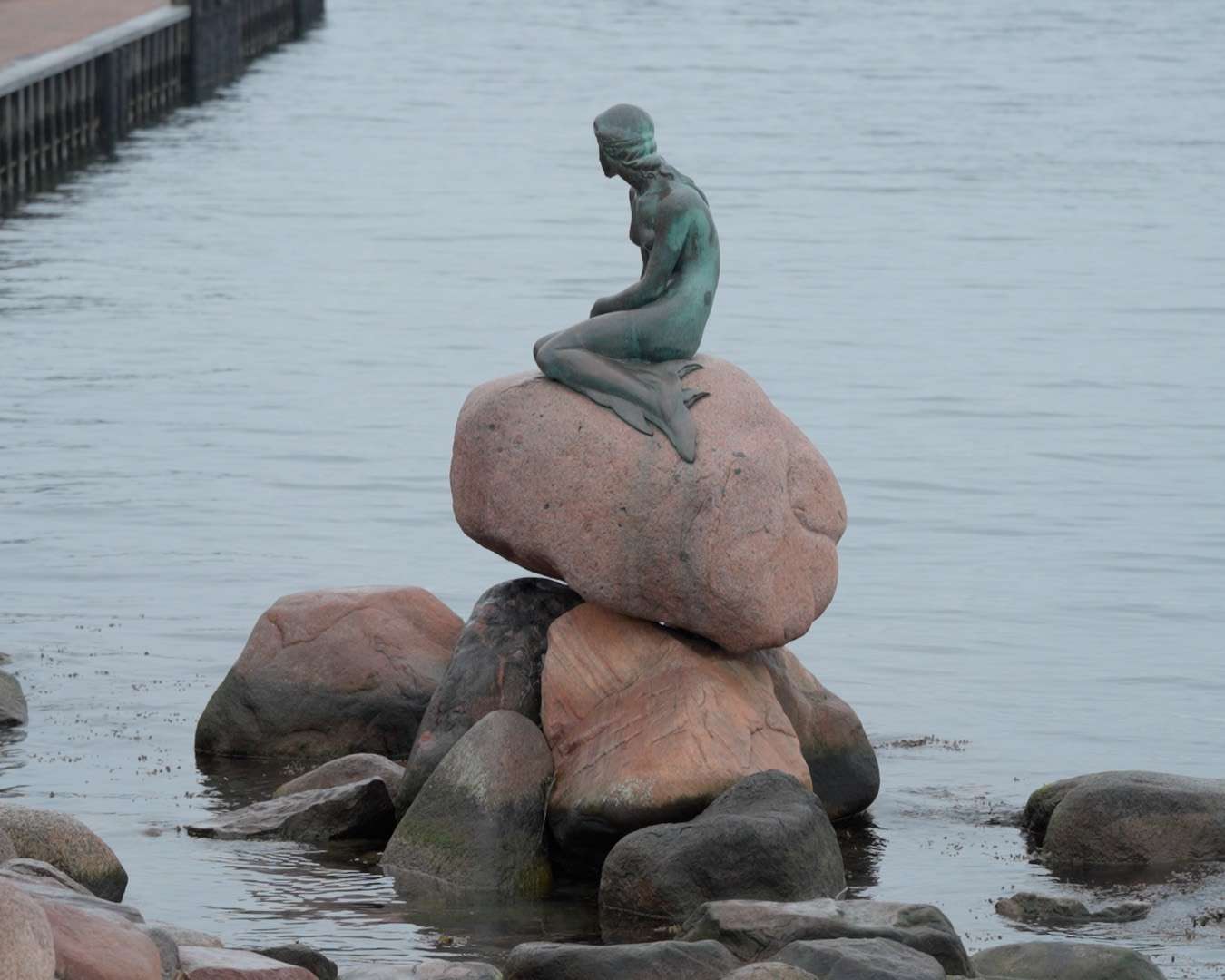 The Little Mermaid on the harbour rocks with open water behind her, Copenhagen