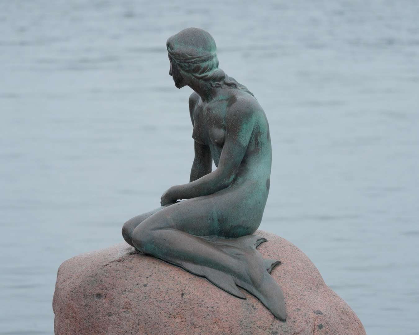 The Little Mermaid bronze seen from the side on her rock at Langelinie, Copenhagen