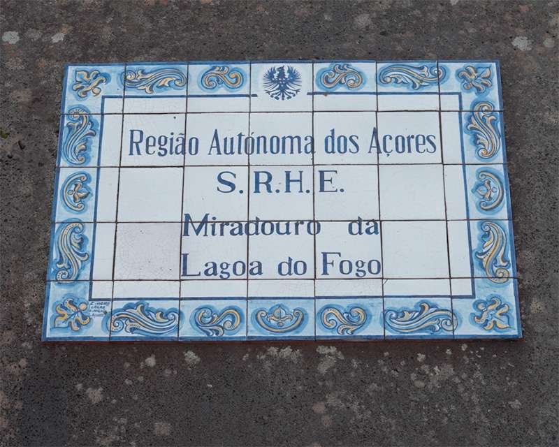 Blue and white azulejo sign set into the asphalt reading Miradouro da Lagoa do Fogo, Azores