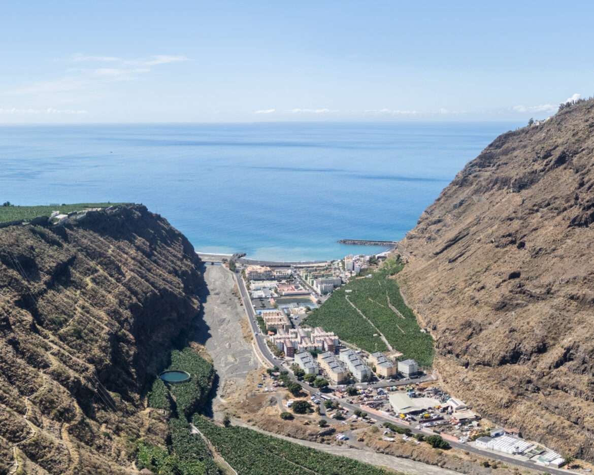 Aerial view of Puerto de Tazacorte, its black beach and the cliffs above the Angustias ravine, La Palma