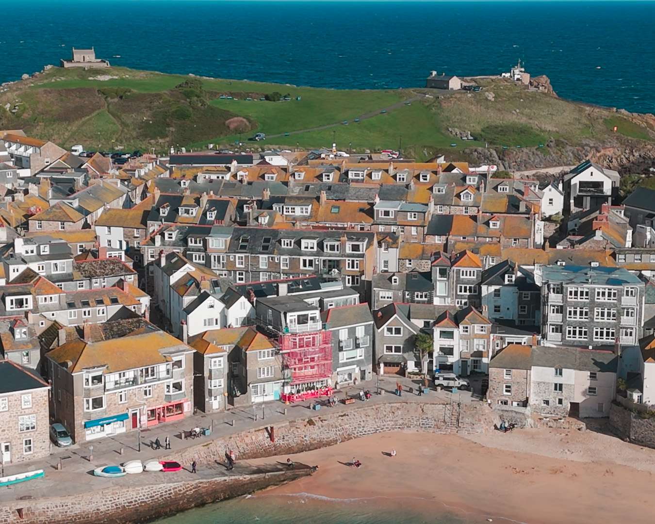 Aerial view over the packed roofs of St Ives down to the harbour beach, Cornwall