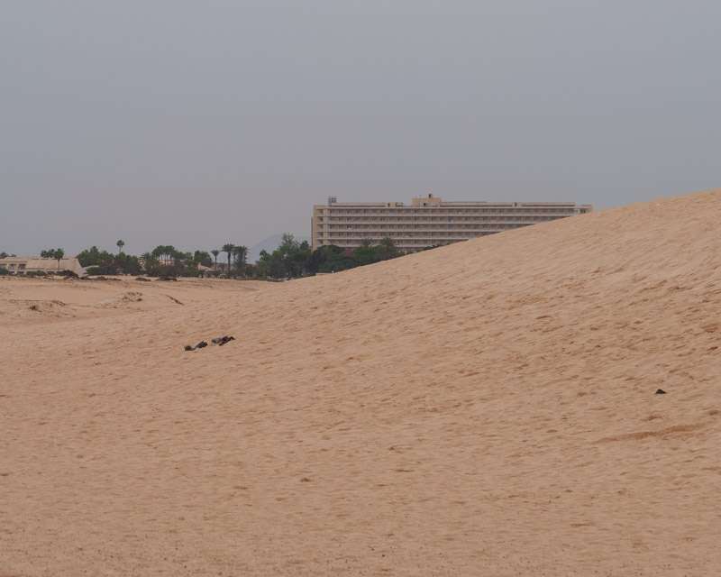 Hotel block standing directly behind the protected dune field of Corralejo, Fuerteventura