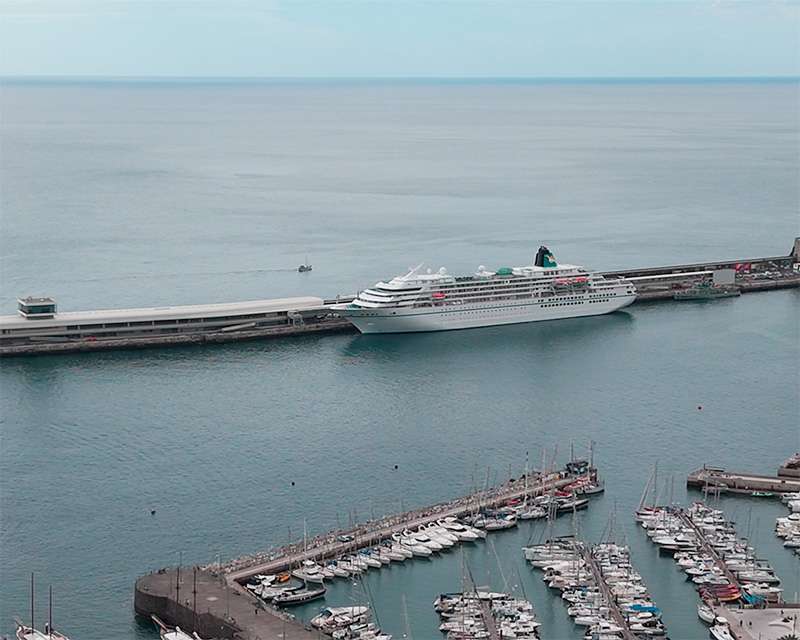 Cruise ship alongside the Funchal breakwater with the marina and the city behind