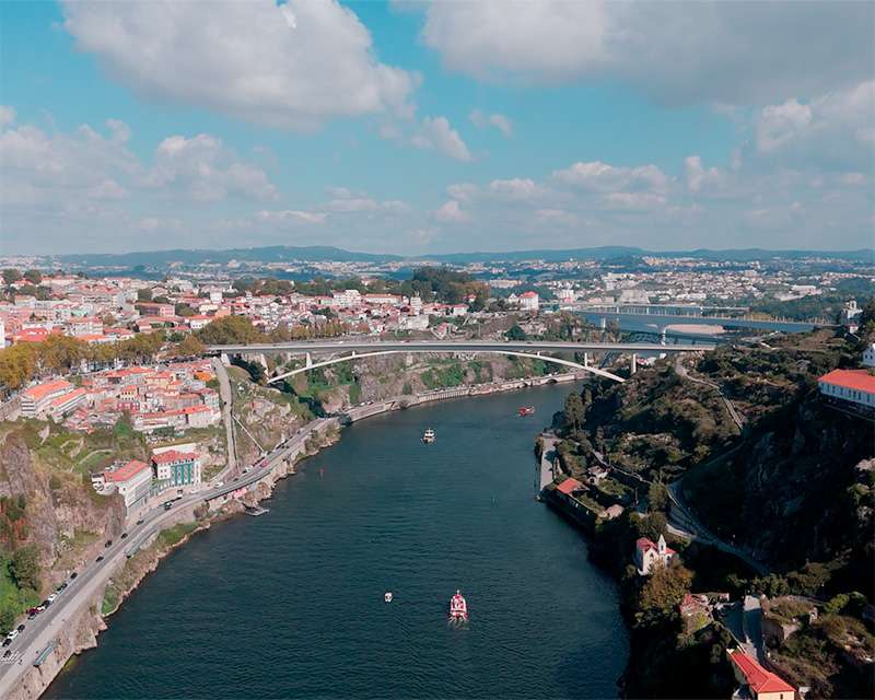 The Douro gorge upstream of Porto with the shallow arch of the Infante bridge between steep banks