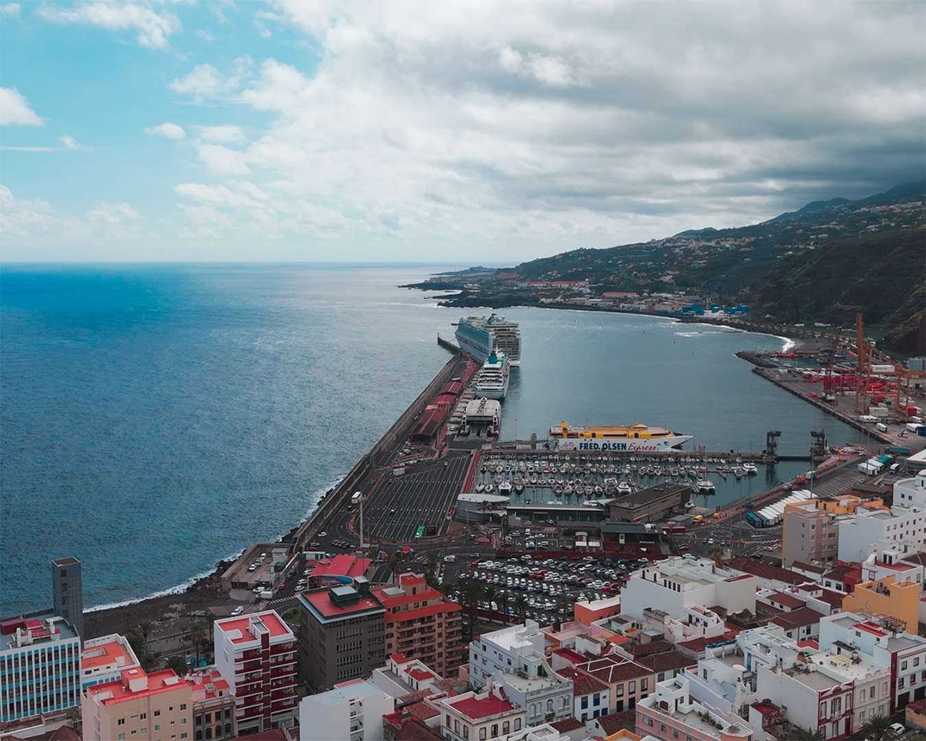Aerial view of Santa Cruz de La Palma with a cruise ship alongside the long harbour mole
