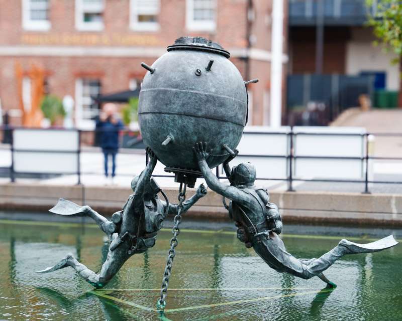 Bronze divers sculpture in the fountain basin at Gunwharf Quays, Portsmouth