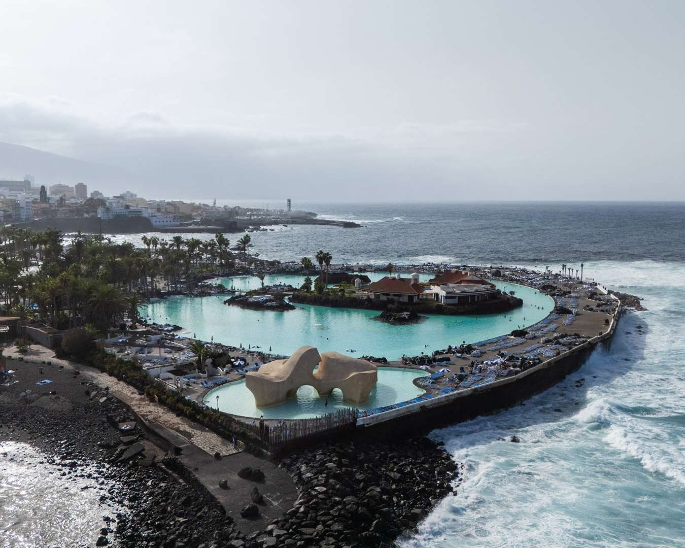 The Lago Martiánez seawater pools from above with Atlantic surf on the lava coast, Puerto de la Cruz