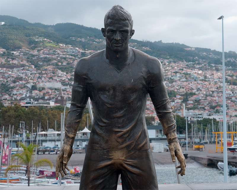 Bronze statue of Cristiano Ronaldo above the marina at Praca do Mar, Funchal