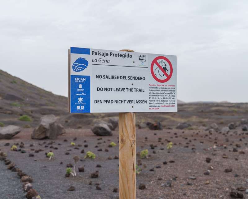 Nature reserve sign on Lanzarote asking visitors not to leave the marked path