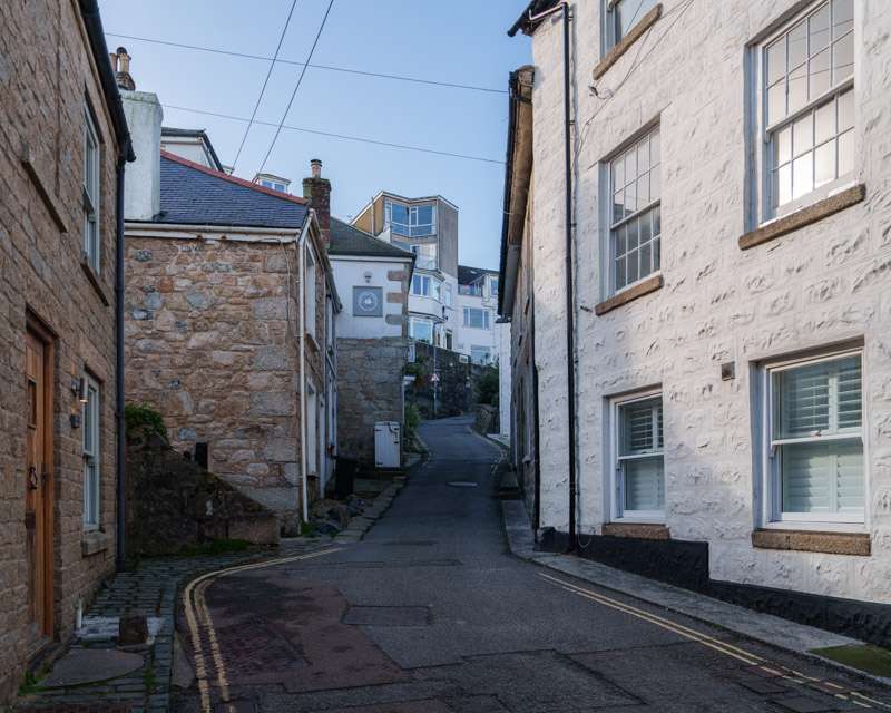 Narrow granite lane climbing away from the harbour in Downalong, St Ives