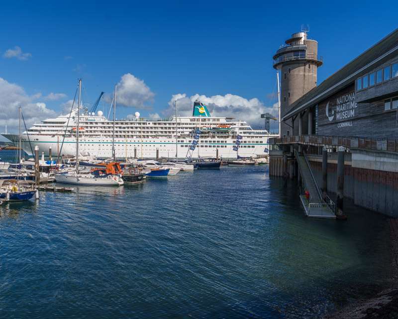 National Maritime Museum Cornwall with a cruise ship moored at Falmouth Docks behind it