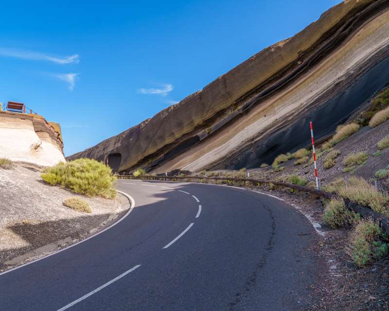 Layered roadcut of white pumice and black and red lapilli at the Mirador La Tarta, Tenerife