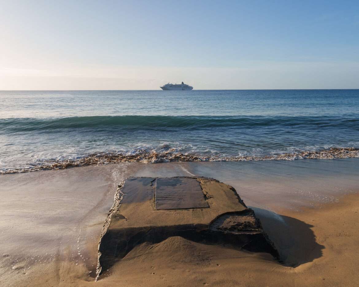 Beach at Porto Santo with a cruise ship lying at anchor on the horizon