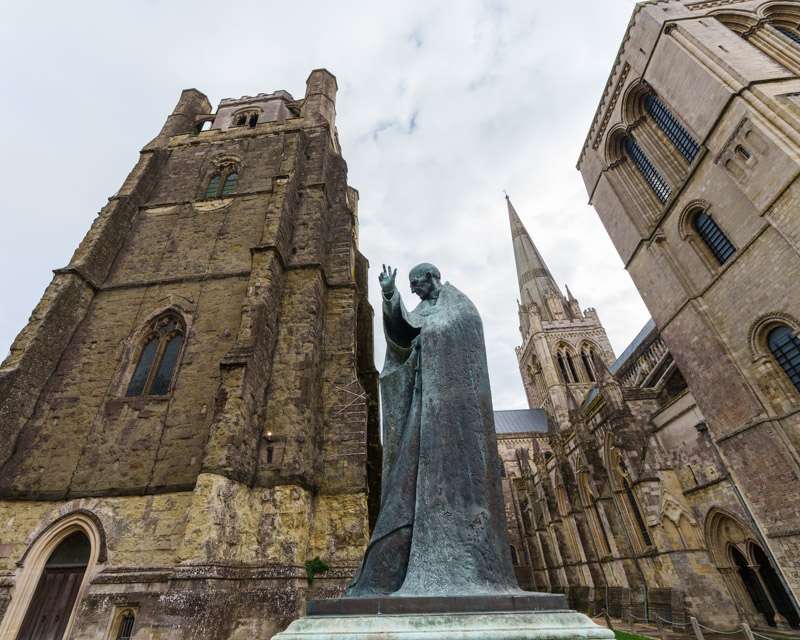 The detached medieval bell tower of Chichester Cathedral with the statue of Saint Richard