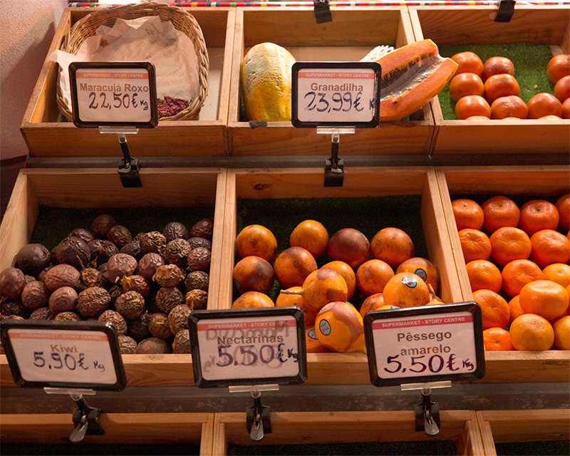 Fruit crates with price tags in a Funchal old town supermarket, passion fruit at 22.50 euros a kilo
