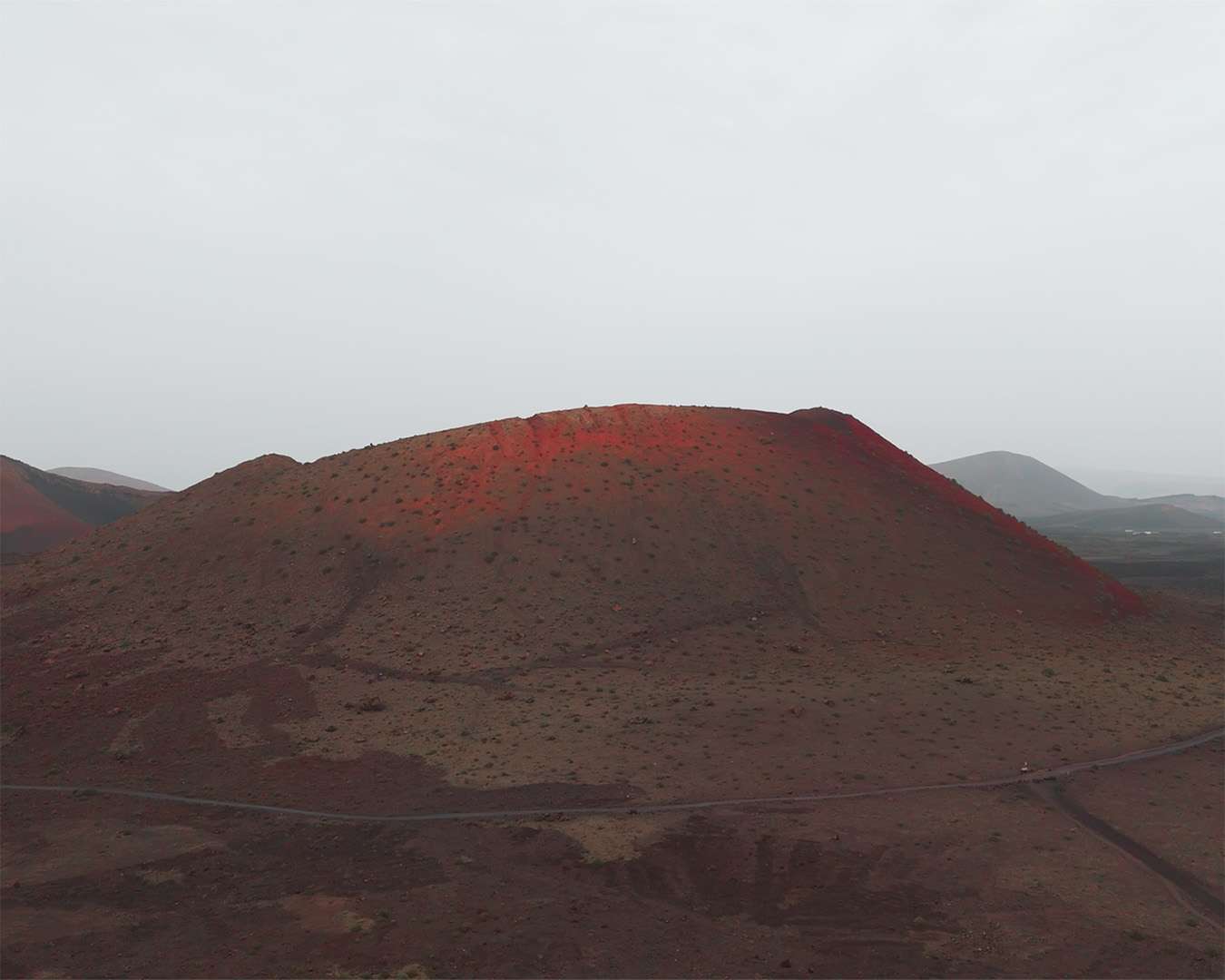 Montaña Negra from the air, a dark rounded cone in the lava field of Lanzarote