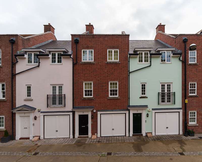 Pastel-painted townhouses on a quiet street inside the walls of Chichester