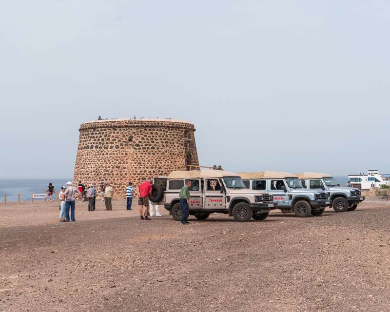 The Torre del Tostón at El Cotillo with the excursion jeeps parked on the sand in front