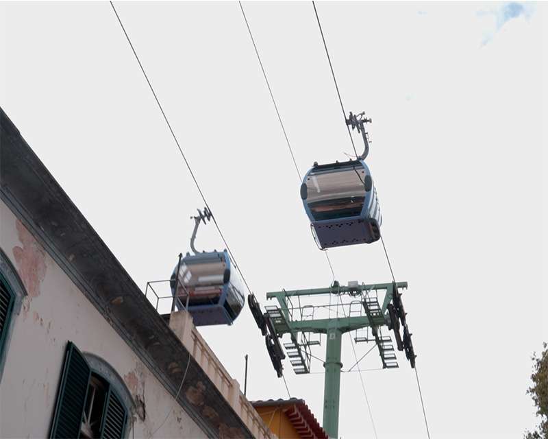 Cable car cabins to Monte crossing above the rooftops of Funchal's old town