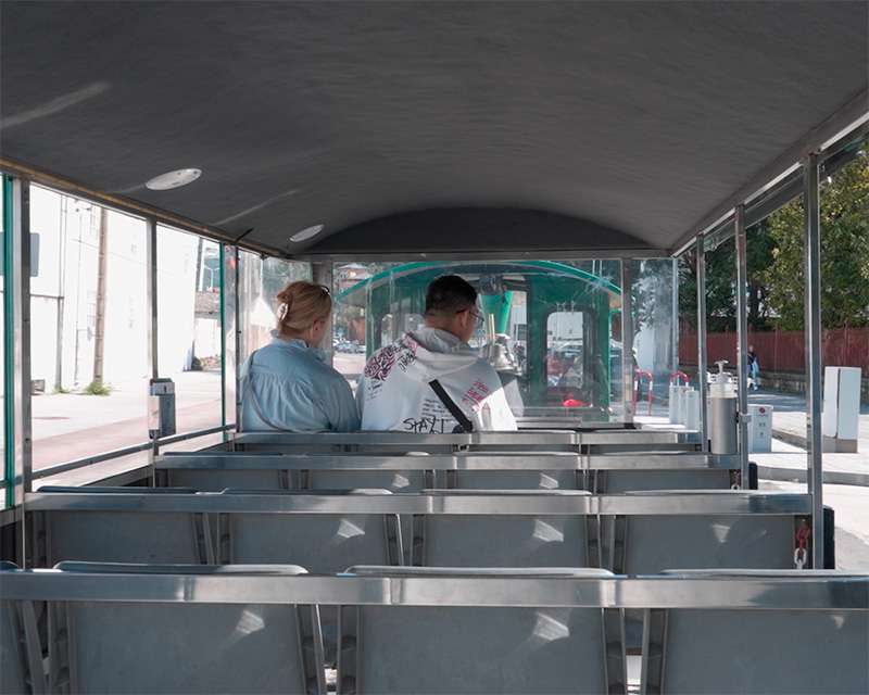 Empty metal benches inside the road train that shuttles between the cruise berth and the centre of Vilagarcía de Arousa