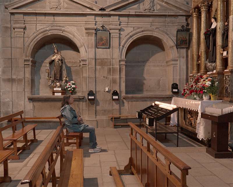 Interior of the San Cristóbal convent church in Vilagarcía de Arousa with side altars and wooden pews