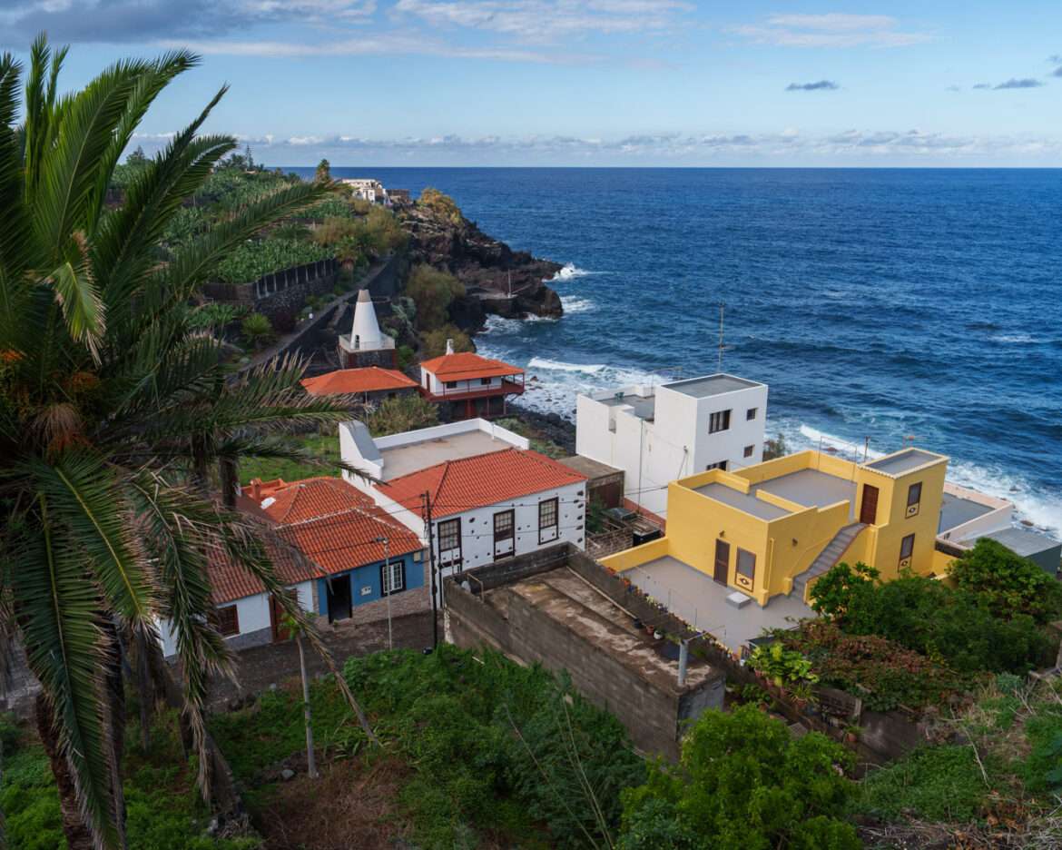 San Andrés on La Palma seen from above, palms and painted houses on the slope down to the Atlantic