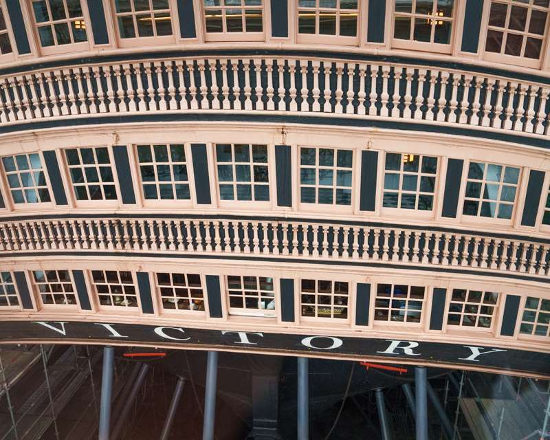The scaffolded stern of HMS Victory with her name board, Portsmouth Historic Dockyard