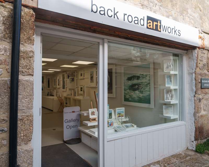 Open door of a small art gallery in a back street of St Ives