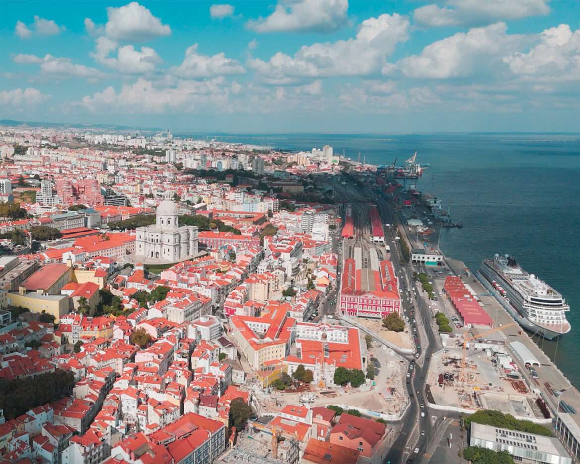 Alfama's rooftops from above with the Tagus and a cruise ship at the Lisbon terminal