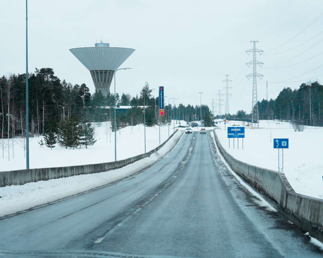 Road back into Oulu past the water tower on a grey afternoon in late March