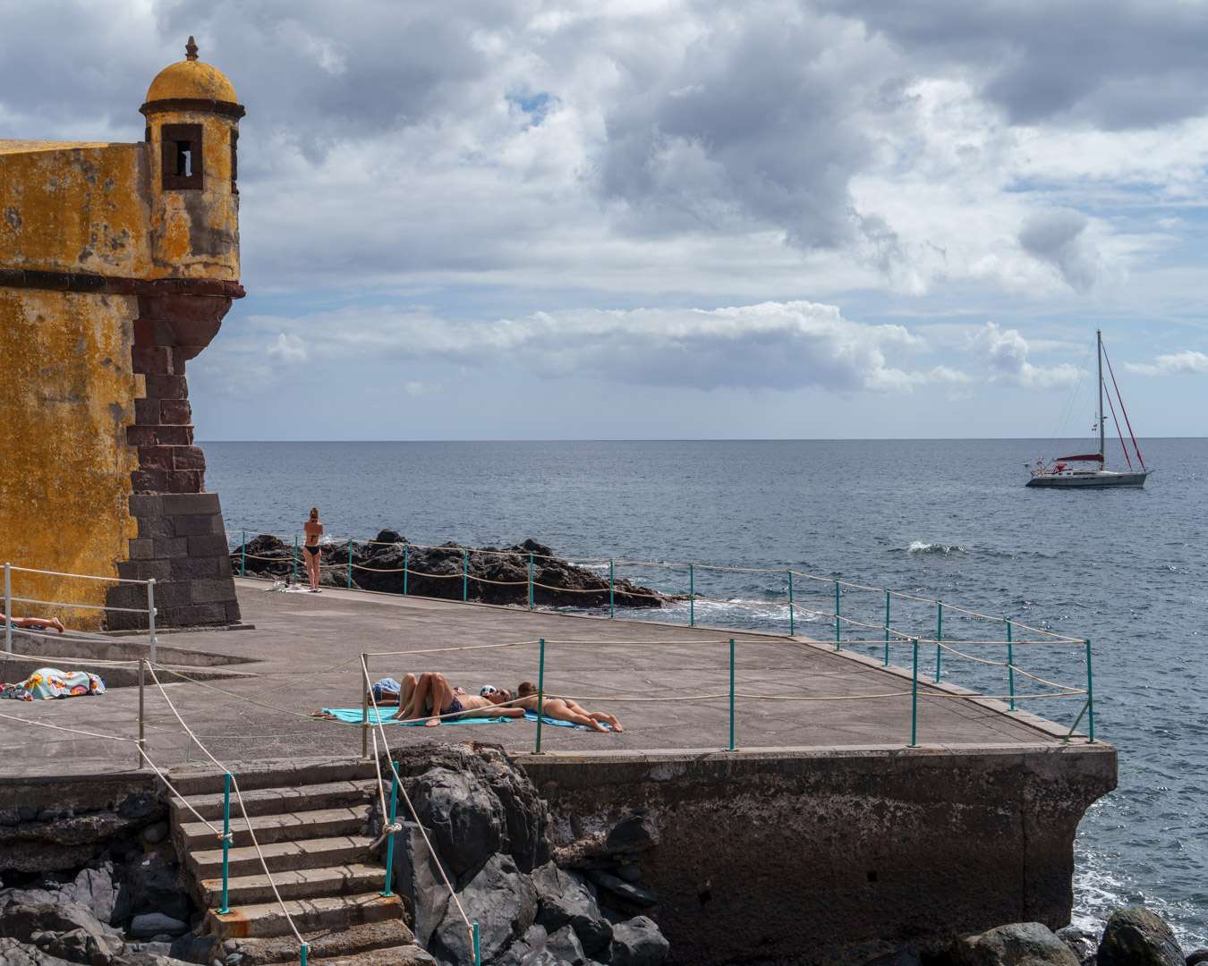 Concrete bathing platform below the yellow walls of Forte de Sao Tiago, Funchal