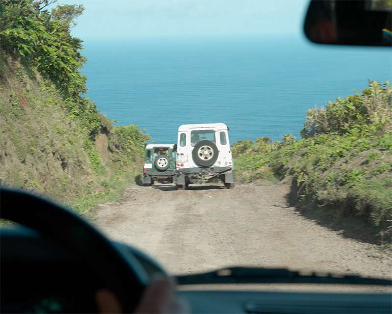 White Land Rover on the unsurfaced rim track high above the Atlantic, São Miguel