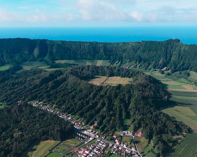 The whole Sete Cidades caldera from above, village and fields on the crater floor